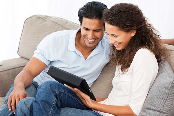 image of a couple looking at their tablet device